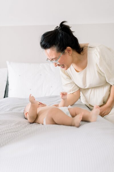 mom tickling baby