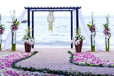 Outdoor wedding ceremony site with pink themed florals