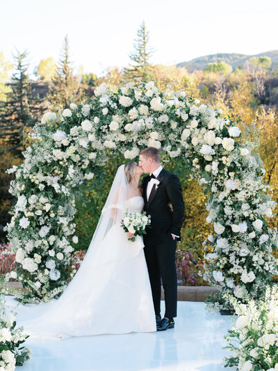 Bride and groom kiss, photographed by Aspen Wedding Photographers Sarah Nann