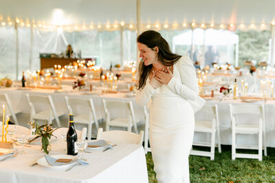 Bride looking at the wedding tables designed by One Bell Designs