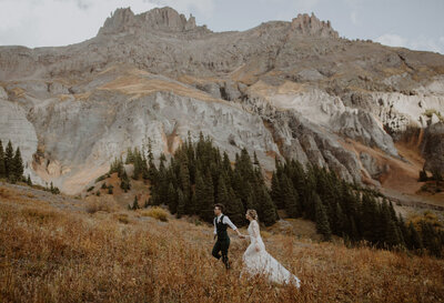 Two brides walk through the Colorado mountains