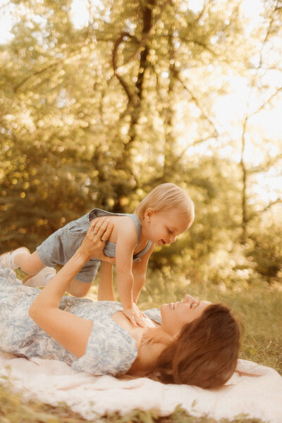 mom and toddler laughing together during golden hour outdoor photo session in Nashville