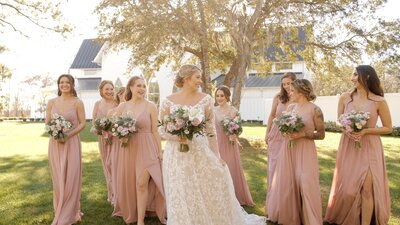 Bride and bridal party in pink dresses prepare for wedding