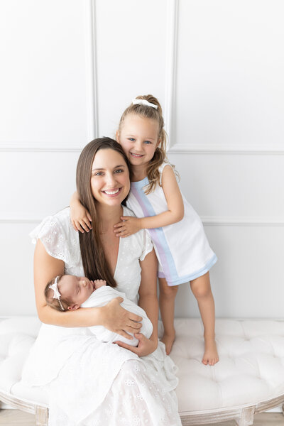 Smiling family on bench in studio