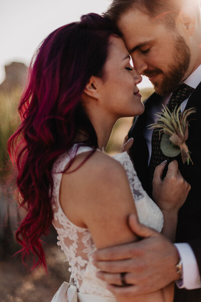 Pink hair bride and groom wedding photos during golden hour at their Joshua Tree elopement