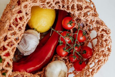 tomatoes in a mesh grocery bag