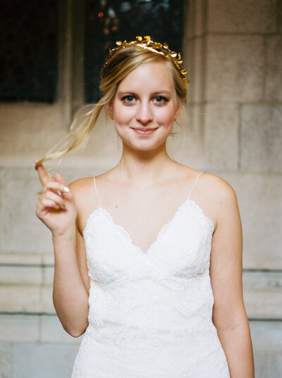 Playful young bride at the Sandstone villa winery in Santa barbara county with a gold crown and Sarah Seven gown.