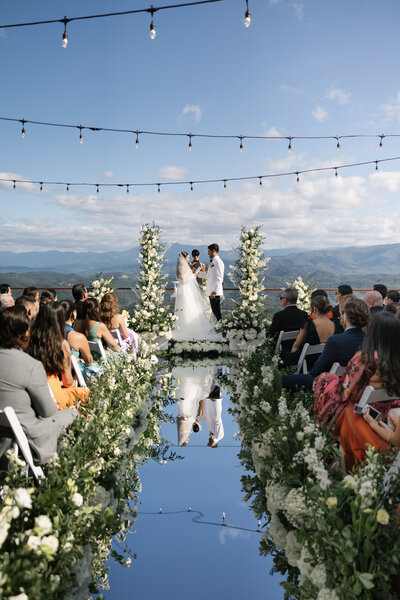 Couple up close with groom kissing the bride's forehead
