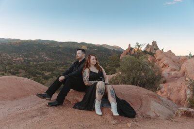 Couple eloping at Garden of the Gods with dramatic red rock formations in the background.