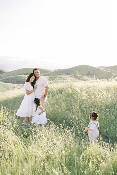 Newborn baby swaddled on a white bed | Fresno family photographer