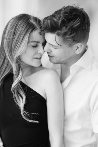 Close up engagement portrait of a couple with noses touching in downtown Calgary Alberta captured as an intimate and romantic moment