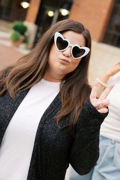 Raleigh event planner and owner Jennifer wearing white heart glasses