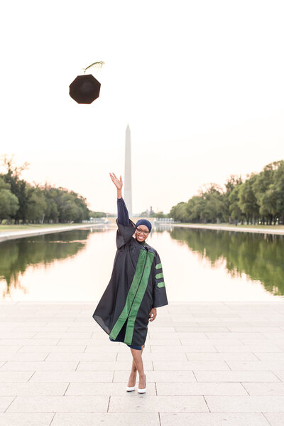 graduate  at lincol memorial throwing cap pose