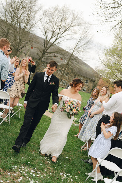 A young bridal couple swing dancing after their morning wedding outside of Austin, Texas. 