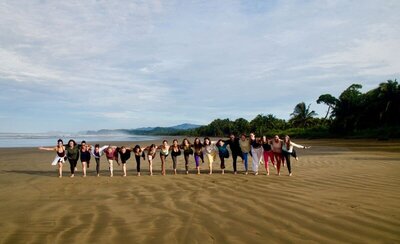 Outdoor yoga class surrounded by tropical nature during yoga instructor course in Costa Rica