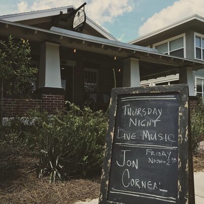 Jon Corneal Signage sitting outside in the front lawn of Hillcrest Coffee