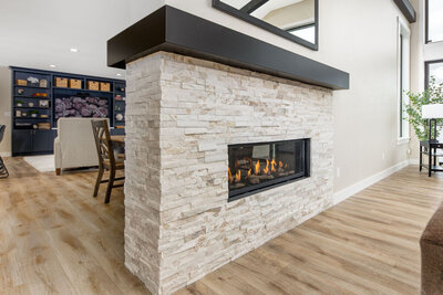 Modern fireplace surround with integrated cabinetry and natural materials.