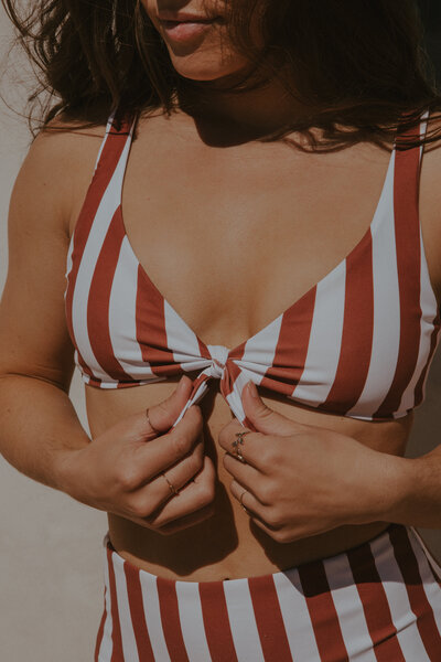 girl posing in stripe bikini top