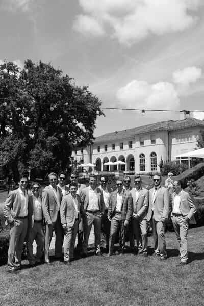 Black and white groomsmen portrait at Commodore Perry Estate in Austin, Texas. A timeless and sophisticated wedding moment with classic estate architecture in the background.