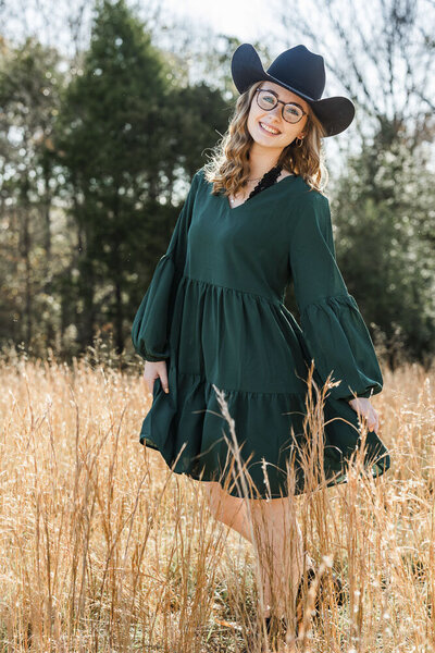 Girl wearing a cowboy hat in a field