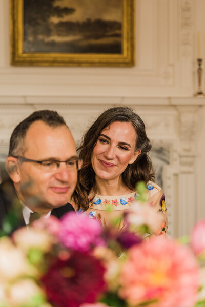 A couple sitting smiling at their micro wedding ceremony at Powel House and Garden in Philadelphia.