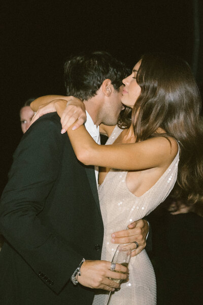 couple hugging at reception. 