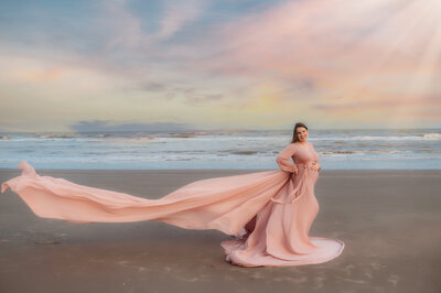 Pregnant woman poses for Maternity Photos on Folly Beach in Charleston, SC.