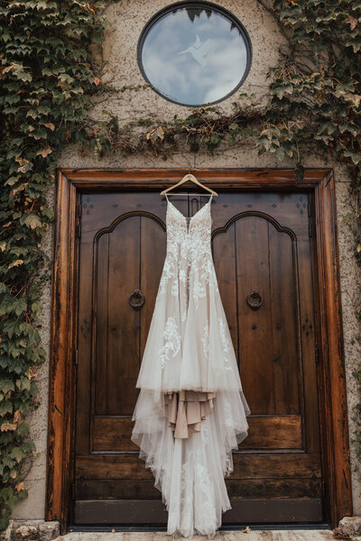 wedding dress hanging near reception door