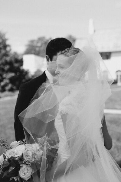 bride poses with luscious bouquet on wedding day
