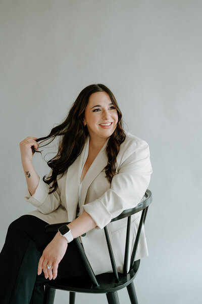 Brand and Showit website designer in Fort Wayne, IN sitting in a chair