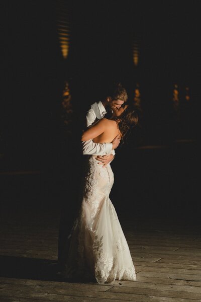 Wedding Couple kissing at night at Mount Norquay Ski Lodge in Banff