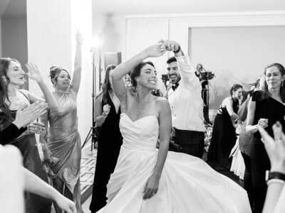 Groom twirls bride as they dance at their Hotel Washington Reception