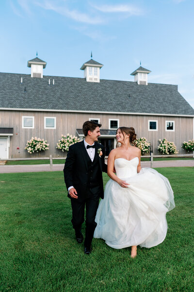 bride and groom looking at each other lovingly outside taken by minneapolis wedding photographer bauer creative