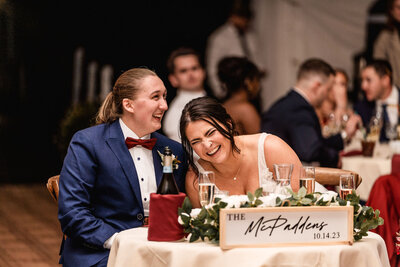 Couple laughing during speeches at Waterville Valley wedding reception by NH Wedding Photographer Lisa Smith Photography