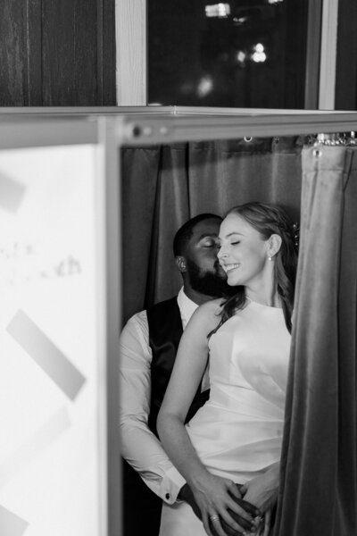 black and white image bride and groom embracing