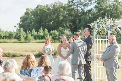 Crystal chandeliers and white beams with greenery