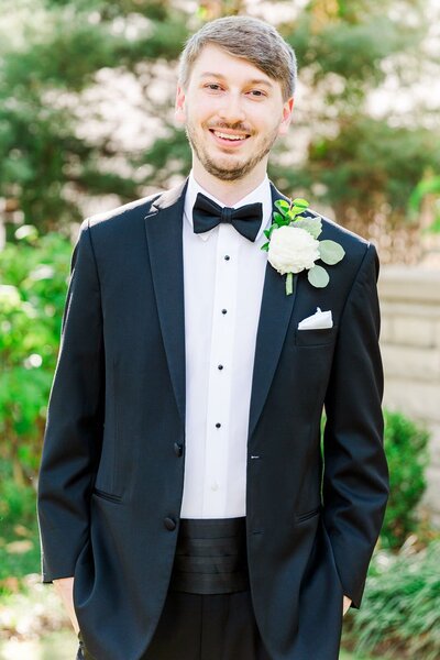Handsome groom in black tuxedo