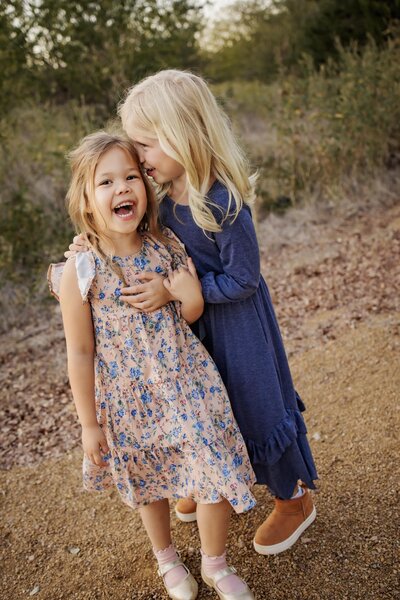 two sisters share a laugh at a trail on Lake Lewisville in The Colony, Texas