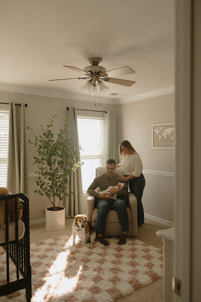 Family posing in newborn's nursery during RVA newborn photographers session