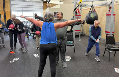 Lori leads a parkinson's exercise class in the Parkinson's warriors gym