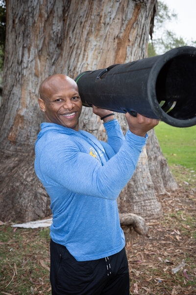 smiling man holding fitness equipment