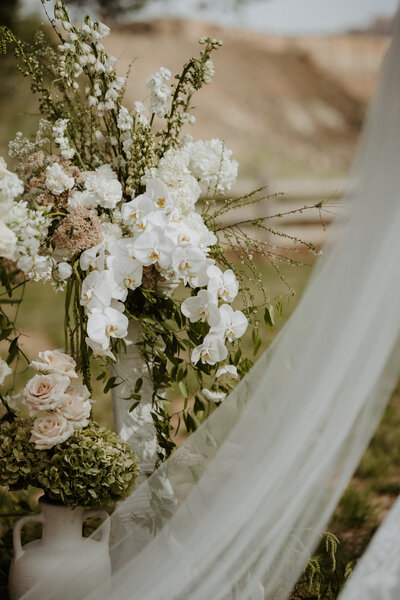 Dreamy bridal veil flowing in the wind during an intimate elopement at Zion National Park—capturing romance and adventure in a breathtaking natural setting, planned by Watters & Co. Events