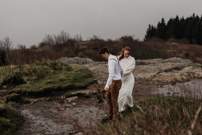 Couple hiking for adventure elopement at Black Balsam Knob in the Blue Ridge Mountains