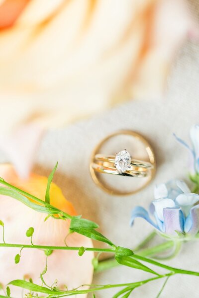 Wedding rings with orange and blue florals | First Presbyterian Church wedding in Columbus Georgia by Wedding Photographer Amanda Horne
