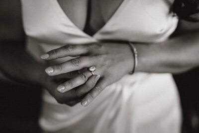 Bride adjusting her engagement ring, a quiet bridal detail captured by Breckenridge wedding photographers.