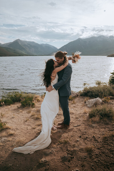 A couple elopes on the shores of Twin Lakes near Leadville, Colorado.