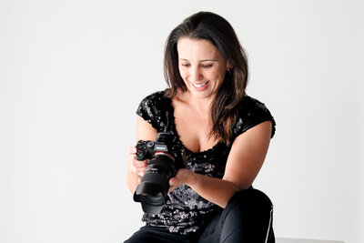 photo of a brand photographer checking the back of the camera