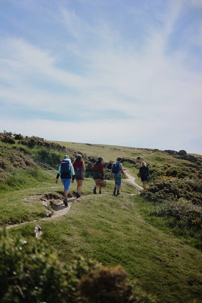 Wedding guests walking the coastal path near Polhawn Fort
