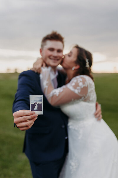 bride and groom smiling at camera