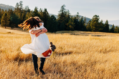 Engagement photo Missoula couple spinning around together at Blue Mountain